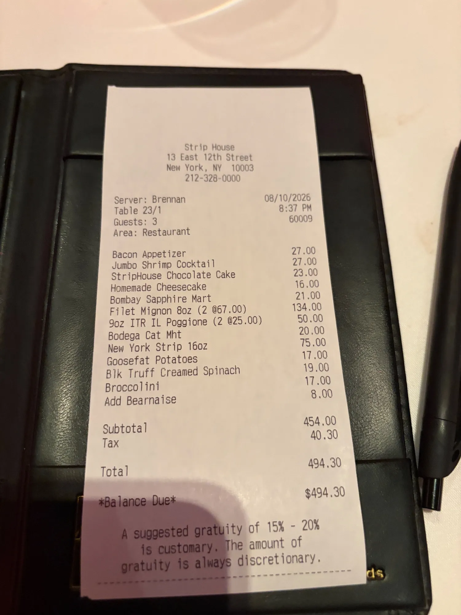 An itemized Strip House receipt showing a subtotal, tax, and printed total.